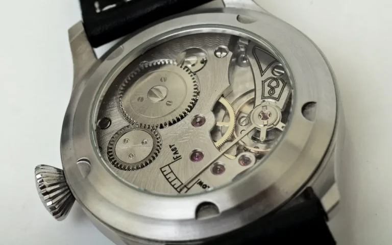 Close-up of a watch's transparent case back, revealing the intricate automatic movement.