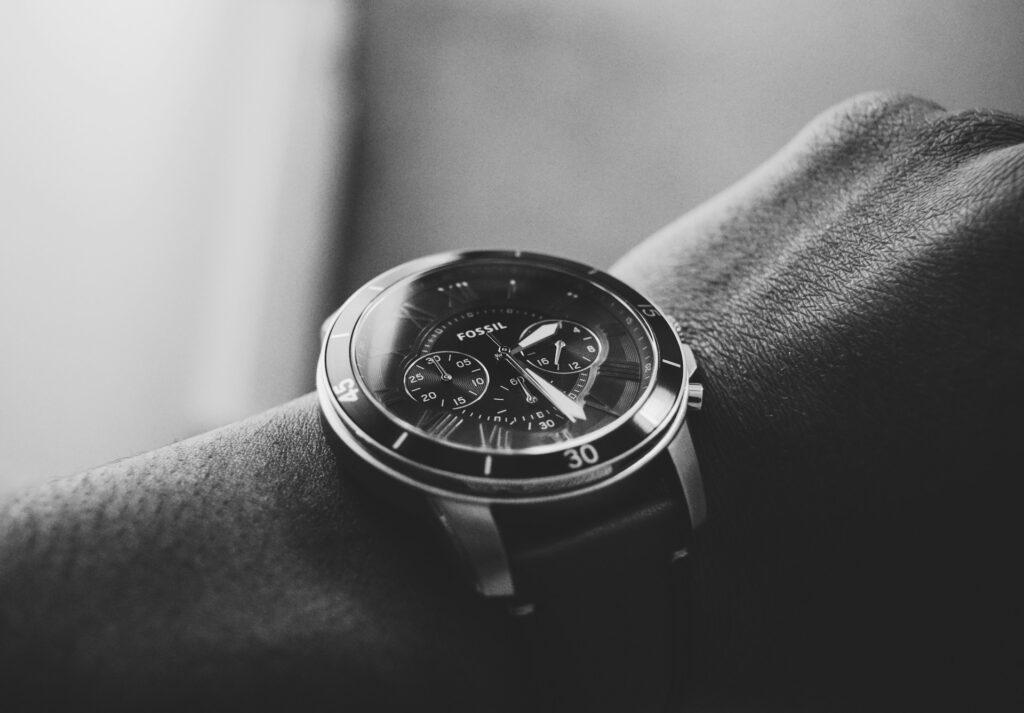 Close-up of a man's wrist wearing a fossil watch with a Mineral crystal