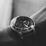 Close-up of a man's wrist wearing a fossil watch with a Mineral crystal