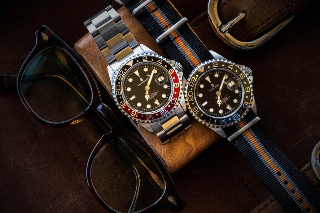 Two watches: one with metal bracelet and second with blue canvas strap