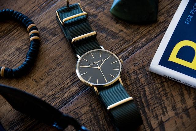 A watch with nylon strap on the table.