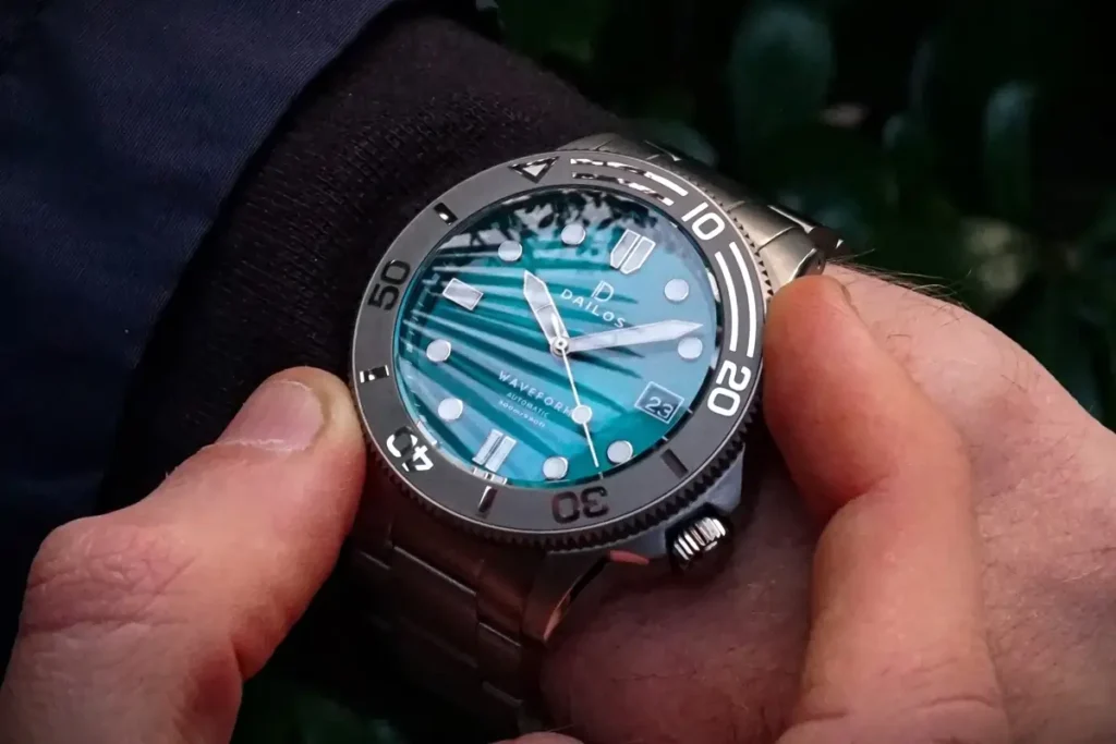 Close-up of a watch bezel being rotated by a person's fingers on his wrist.