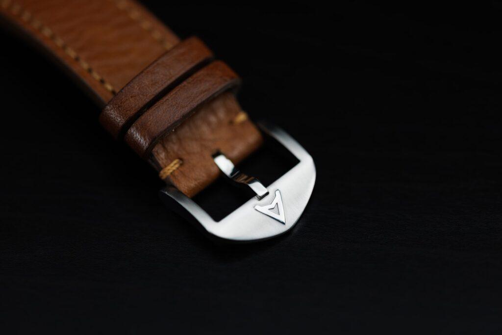 Close-up of shiny premium buckle on a leather watch strap