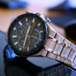 A stylish silver Casio watch resting on a modern black table.