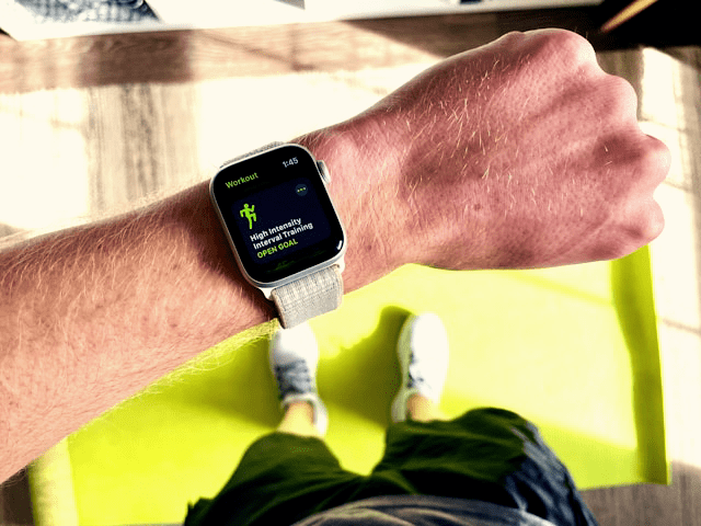 Close-up of a wrist adorned with a sports watch, highlighting the advanced features of an Apple Watch.