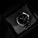 A dress watch elegantly displayed in a black box, highlighting its sophisticated design.