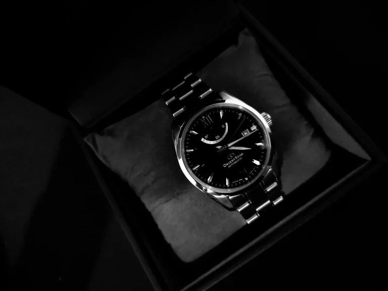 A dress watch elegantly displayed in a black box, highlighting its sophisticated design.