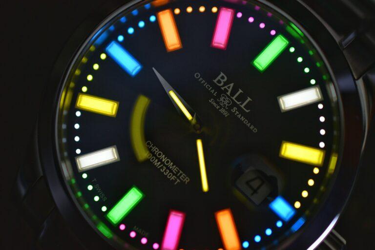 Close-up view of the Ball watch face featuring multi-colored luminescent indices and hands.