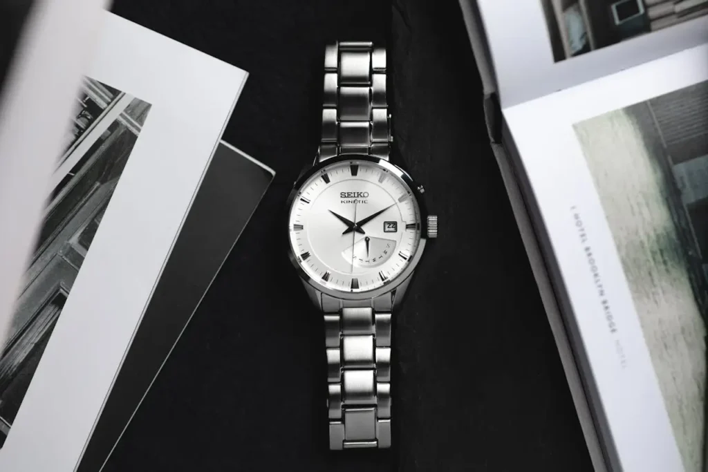 A Seiko Kinetic watch with white dial and silver-tone bracelet.