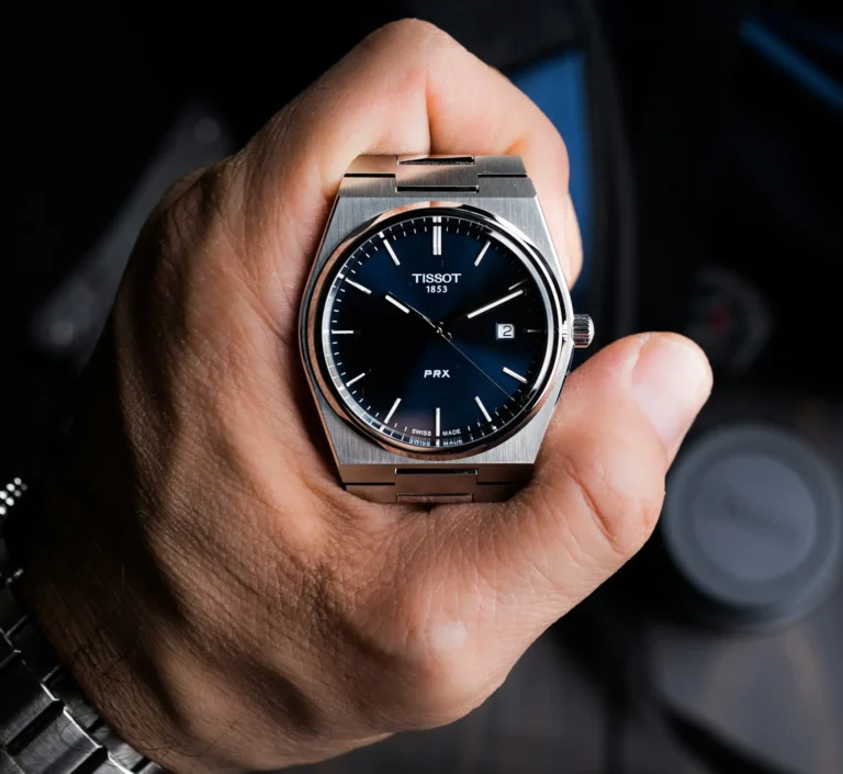 A person holding a Tissot PRX watch