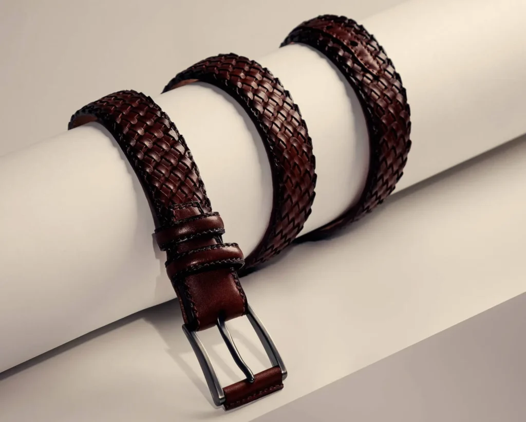 A casual woven belt featuring a stylish braid pattern in rich brown leather.