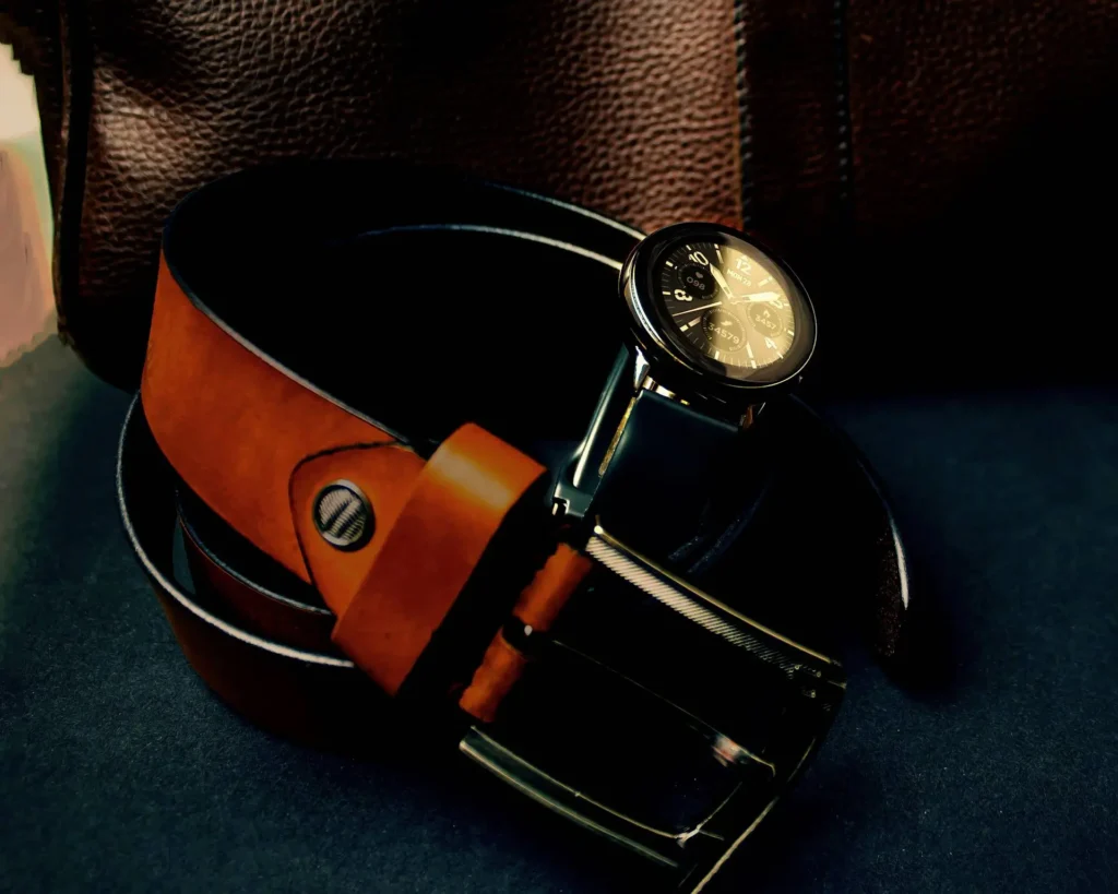 A close-up of a stylish brown leather belt, showcasing its texture and buckle.