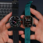 A close-up of two hands displaying two smartwatches.