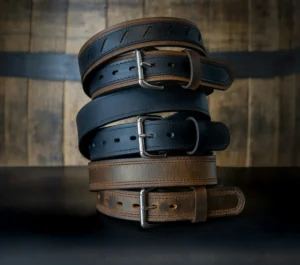 Three distinct leather belts arranged in a stacked formation, showcasing their varied textures and colors.