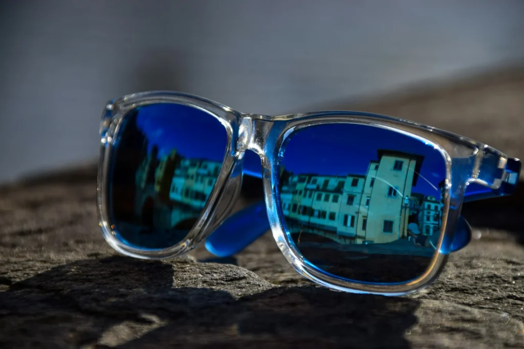 A stylish pair of sunglasses featuring blue and clear lenses.