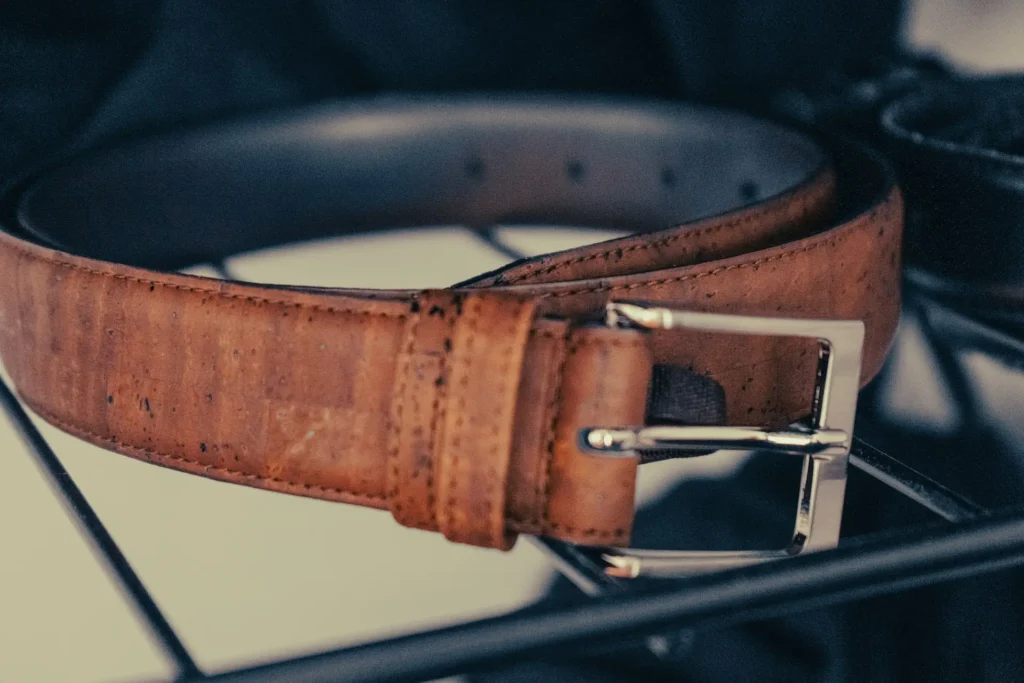 A synthetic belt resting on a rack.