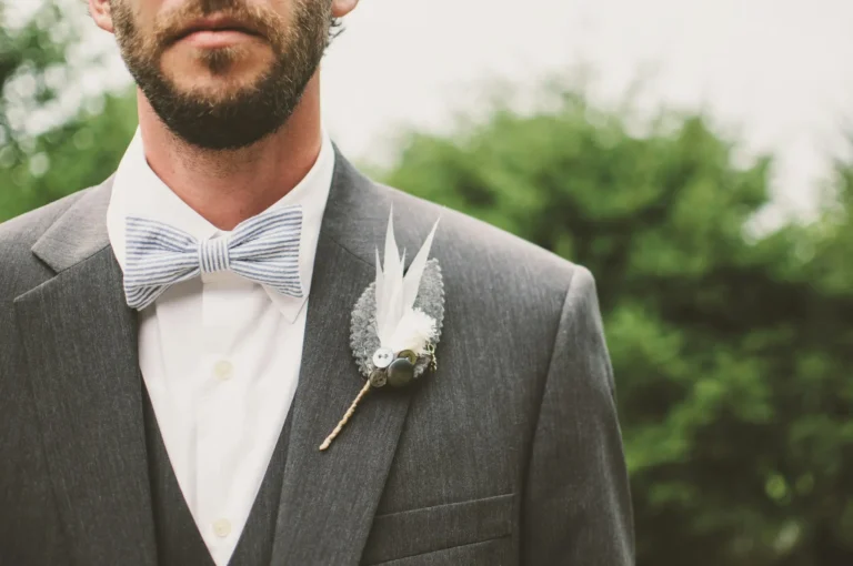 A well-dressed man in a suit and bow tie.