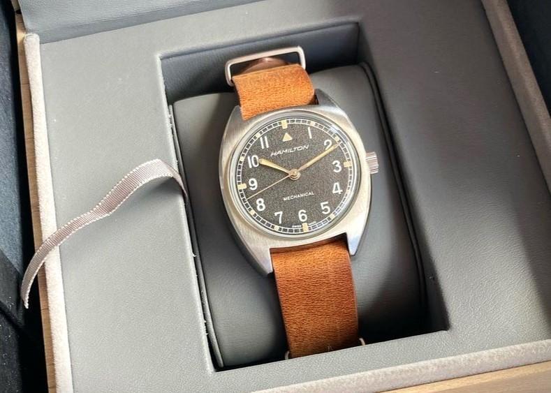 A Hamilton Khaki H76419531 Pilot Pioneer Mechanical watch displayed in a box, featuring a stylish brown strap.