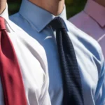 Three men wearing clip-on ties in different colors