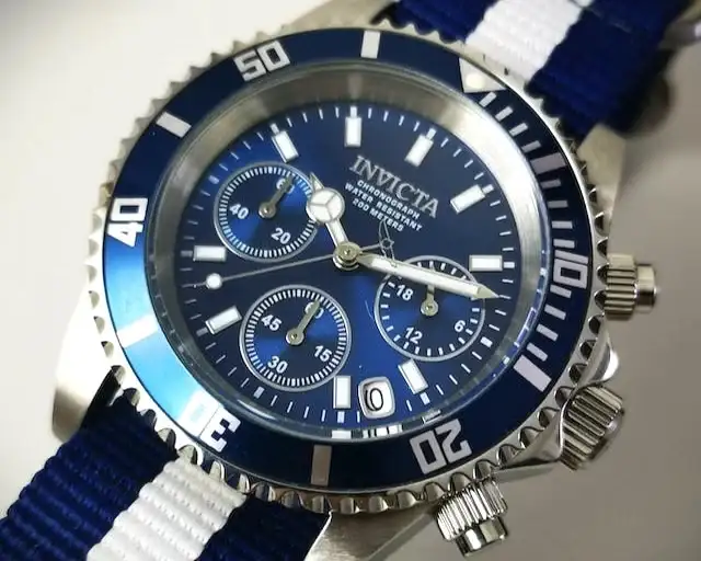 Close-up of an Invicta Pro Diver watch featuring a blue dial, three subdials, and a canvas strap