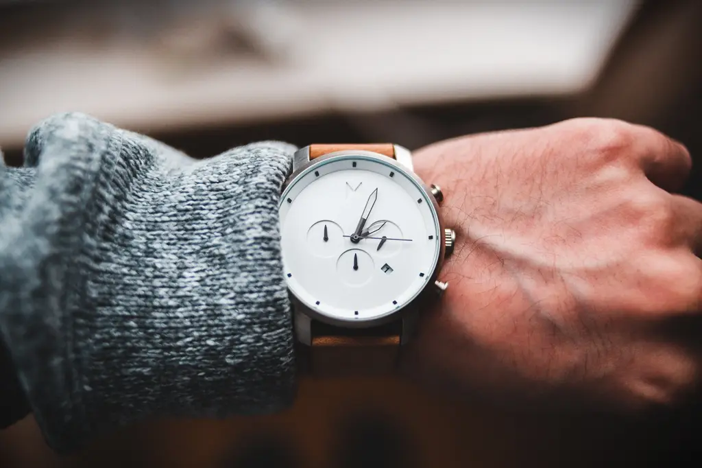 Close-up of a minimalist MVMT watch on a person's wrist