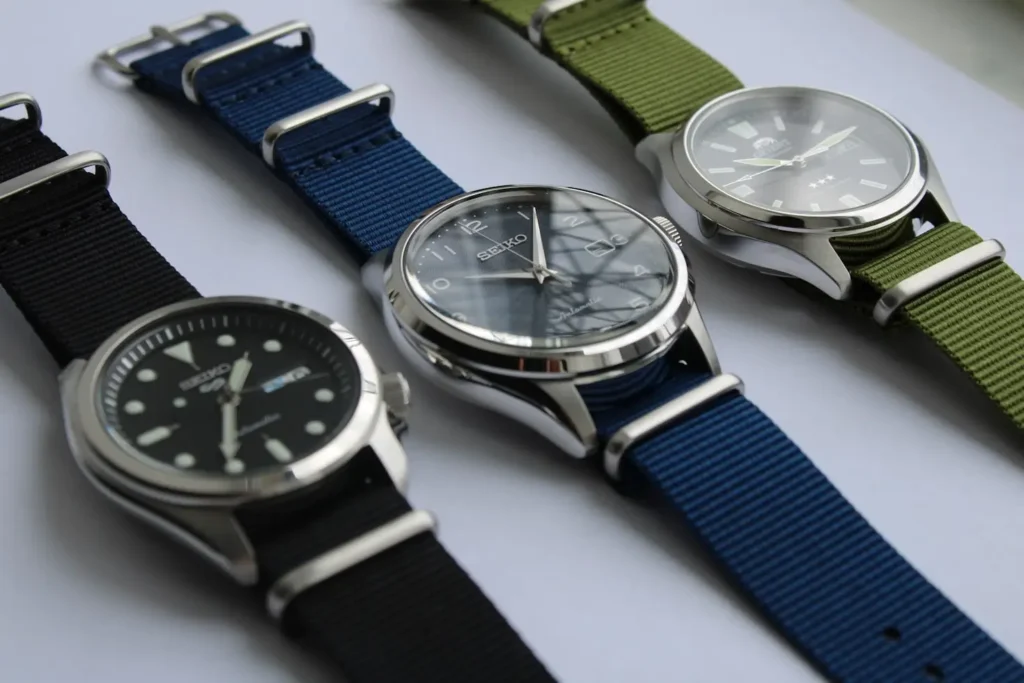 Three Nylon Nato straps with different colors connected to Seiko watches