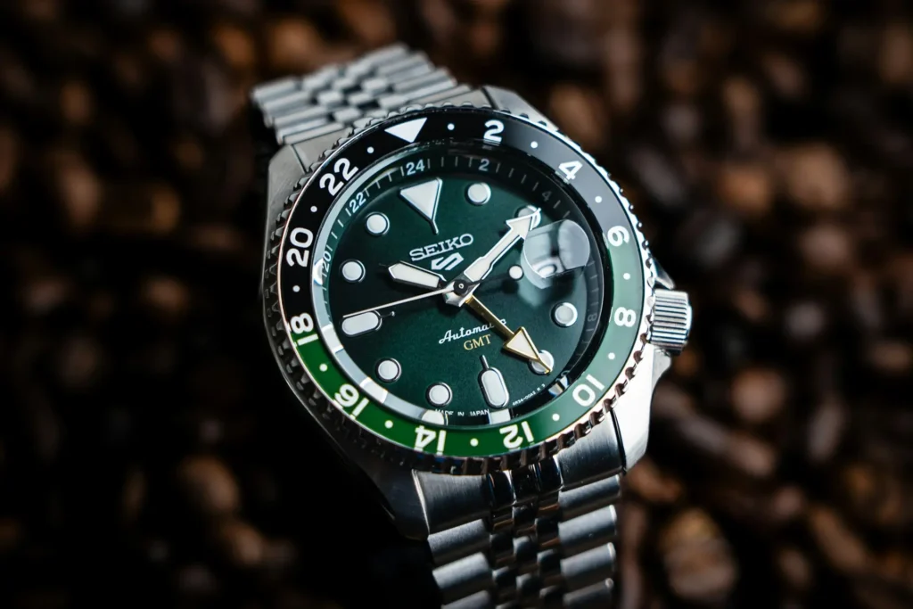 A Green dial Seiko GMT watch with a black-green 24-hour bezel