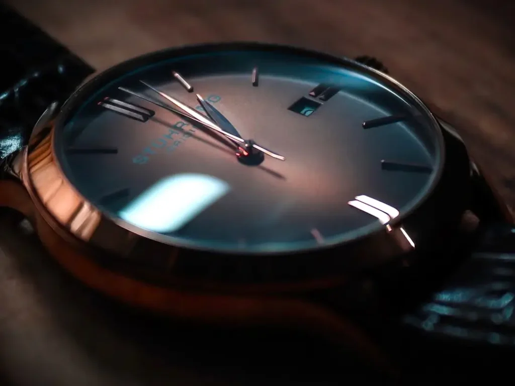 Close-up view of a Stuhrling dress watch with a rose-gold case and a minimalist dial featuring a small date window.