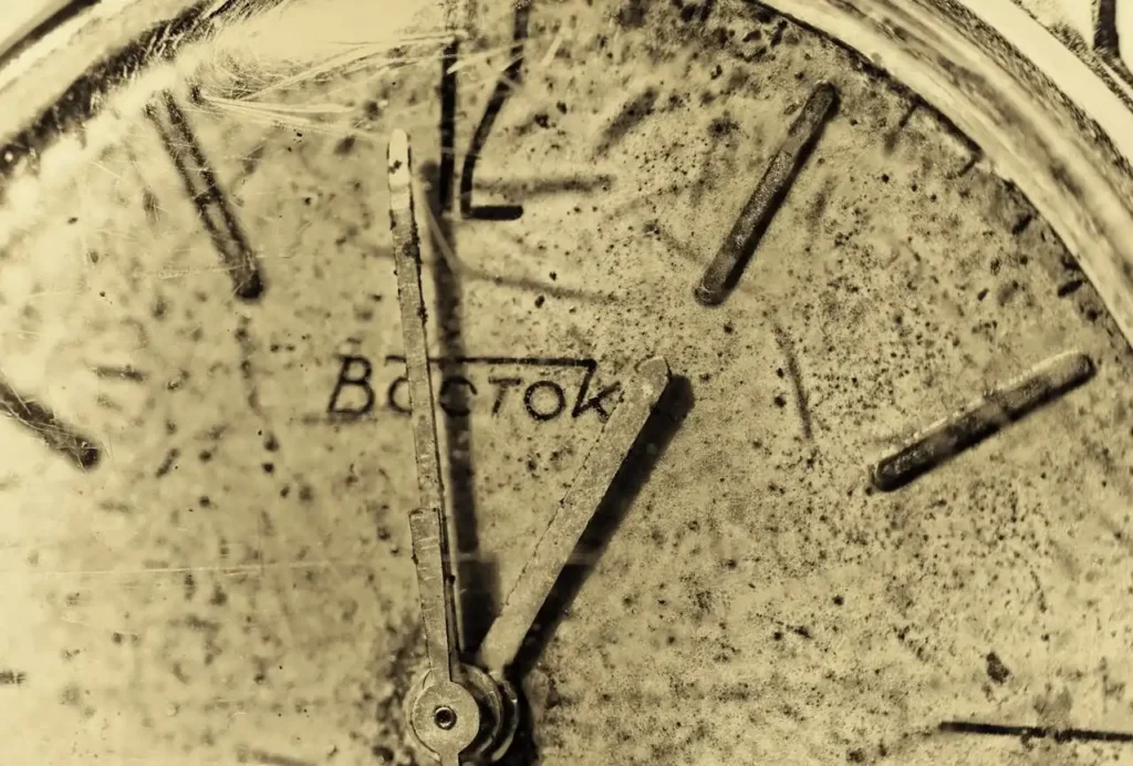 Close-up view of the Vostok Vintage watch logo and its hands