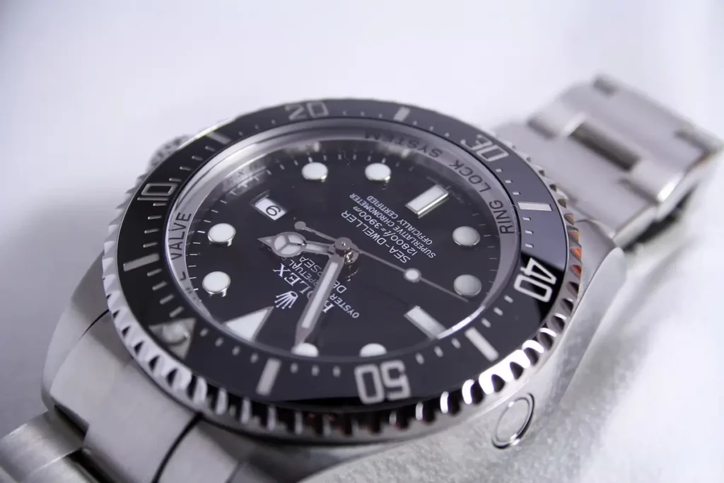 Close-up of a coin-edge bezel on a Rolex Deepsea Dive watch.