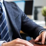 Navy blue tie with subtle stripes on a light blue shirt, ideal for interviews.