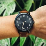 Close-up of a Timex watch on a person's wrist.