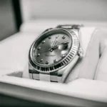 Close-up of a Rolex Oyster Perpetual Datejust dress watch elegantly placed in its box.