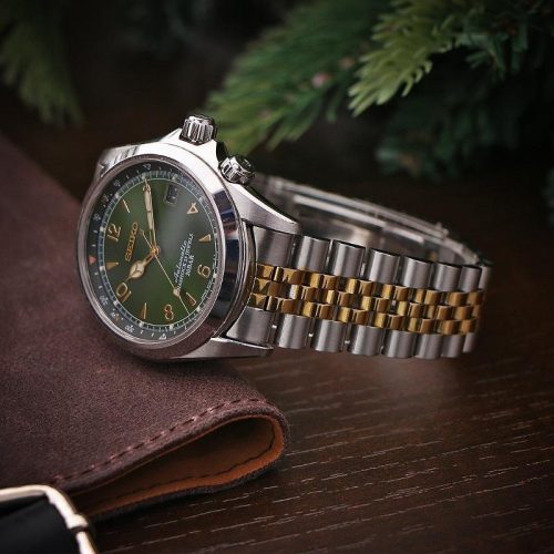 Two-tone Jubilee bracelet attached to a green dial Seiko watch